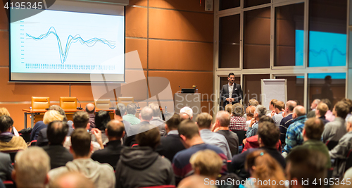 Image of Business speaker giving a talk in conference hall.