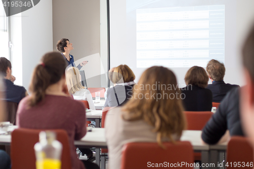 Image of Woman giving presentation in lecture hall at university.