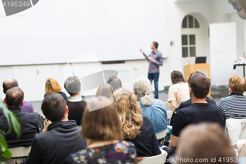 Image of Man giving presentation in lecture hall at university.