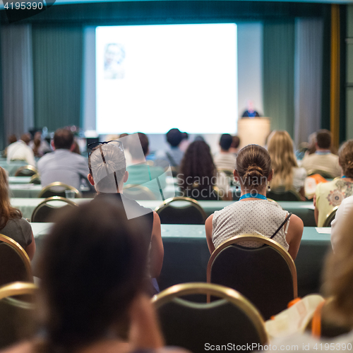 Image of Audience in lecture hall participating at business conference.