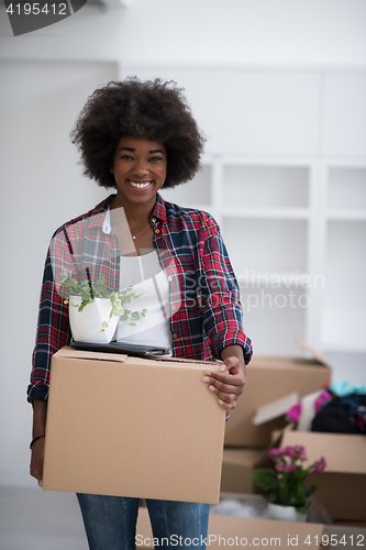 Image of Black girl moving in the new apartment