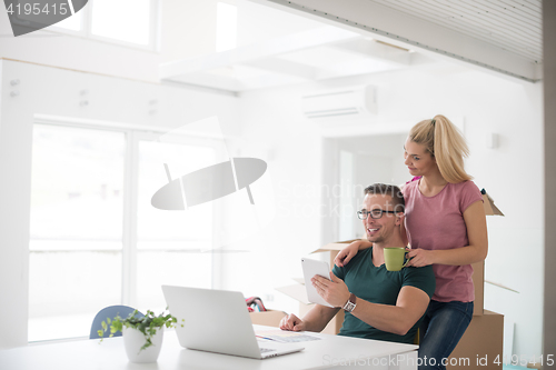 Image of Young couple moving in a new home