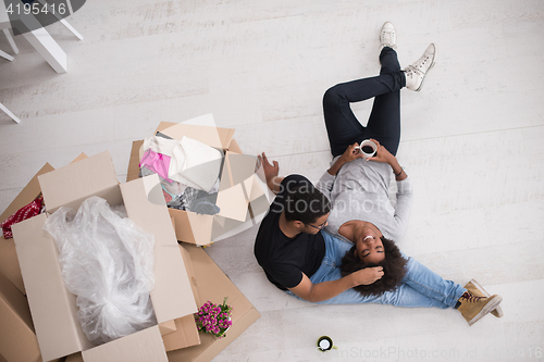 Image of African American couple relaxing in new house