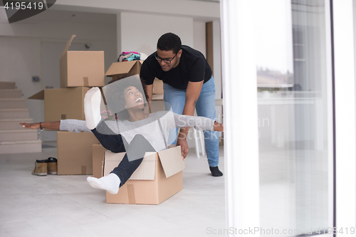 Image of African American couple  playing with packing material