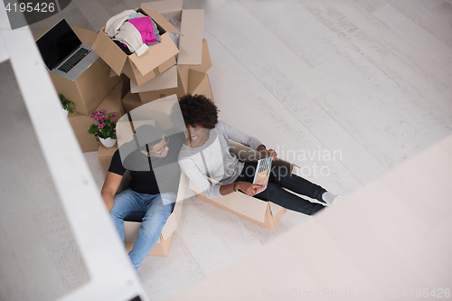 Image of African American couple  playing with packing material