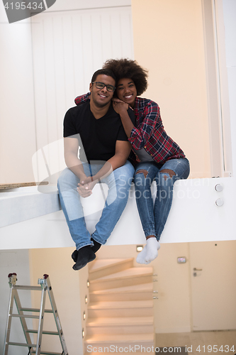 Image of couple having break during moving to new house