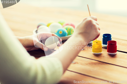 Image of close up of woman coloring easter eggs