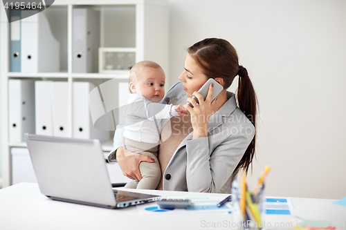 Image of businesswoman with baby and smartphone at office