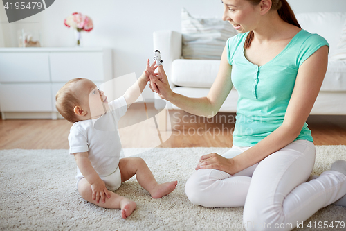 Image of happy mother and baby playing at home