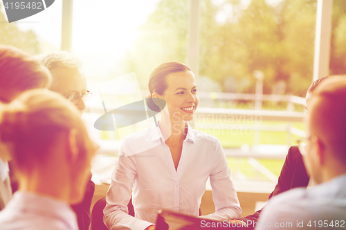 Image of smiling business people meeting in office