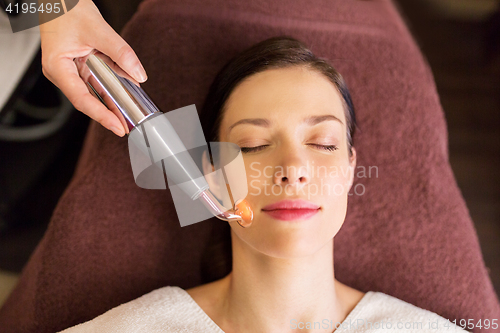 Image of woman having hydradermie facial treatment in spa