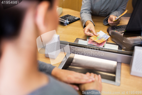 Image of clerk counting cash money at bank office