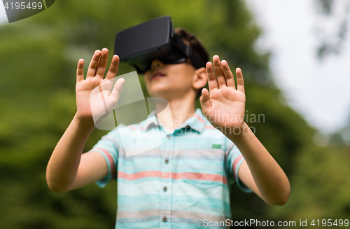 Image of boy with virtual reality headset outdoors