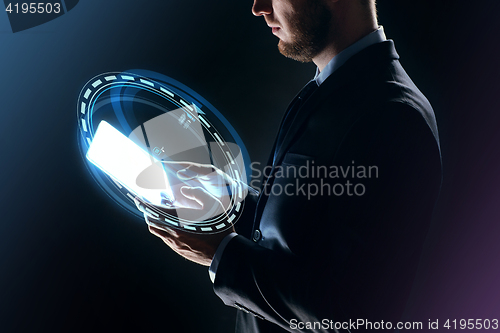 Image of businessman with tablet pc and hologram