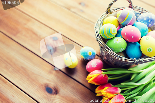 Image of close up of easter eggs in basket and flowers