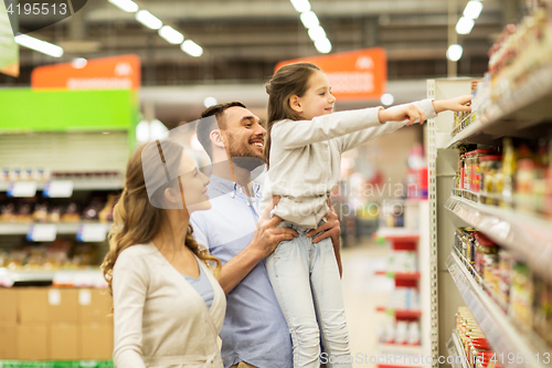 Image of happy family buying food at grocery store