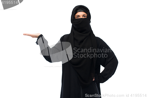 Image of muslim woman in hijab holding empty hand