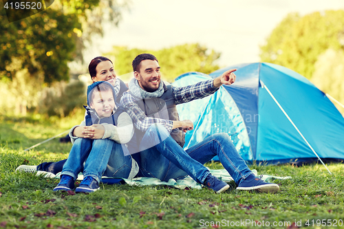 Image of happy family with tent at camp site