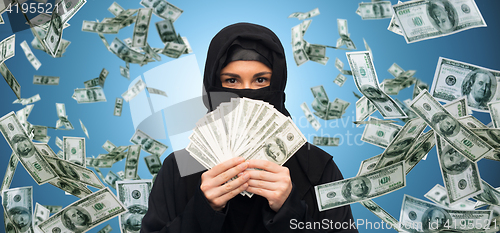 Image of muslim woman in hijab with money over white