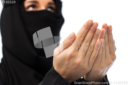 Image of close up of praying muslim woman in hijab 