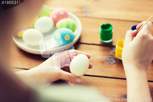 Image of close up of woman coloring easter eggs