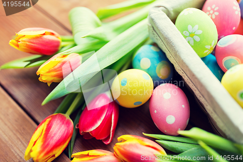 Image of close up of colored easter eggs and flowers