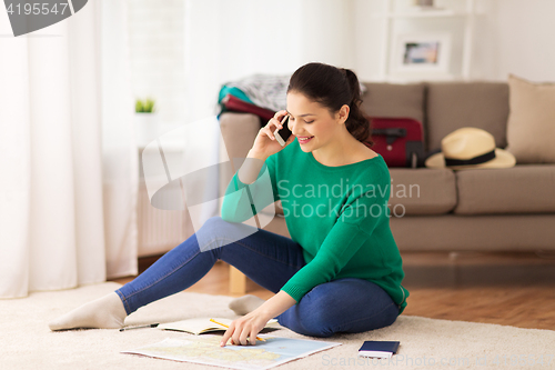 Image of woman with travel map calling on smartphone