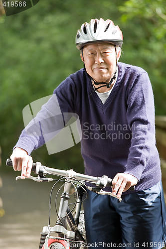Image of Senior asian biking