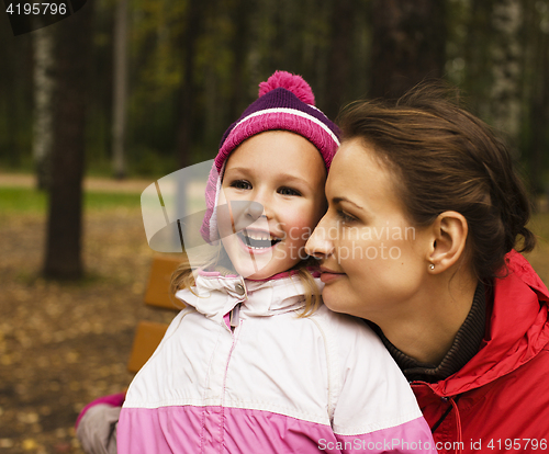 Image of mature real mother with daughter outside in park, recreation concept, lifestyle people 