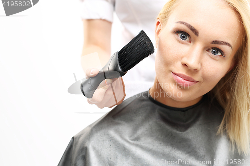 Image of Brush hairdresser. Barber sweeps  hair with arms client 