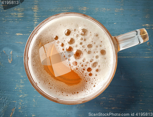 Image of beer mug on blue wooden table