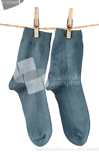 Image of Dark blue socks on rope with clothespins