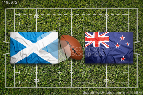 Image of Scotland vs. New Zealand flags on rugby field