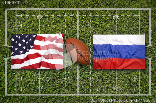 Image of USA vs. Russia flags on rugby field