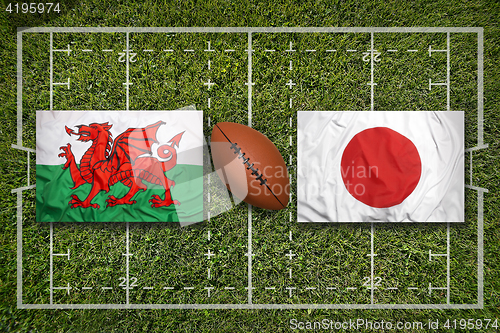 Image of Wales vs. Japan flags on rugby field