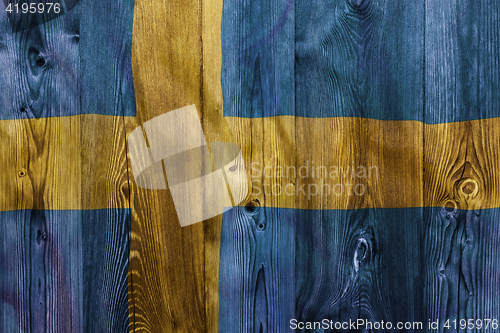 Image of National flag of Sweden, wooden background