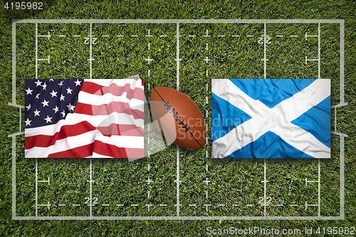 Image of USA vs. Scotland flags on rugby field
