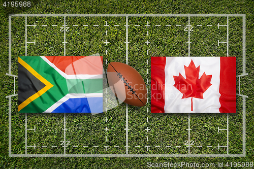 Image of South Africa vs. Canada flags on rugby field