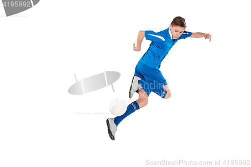 Image of Young boy with soccer ball doing flying kick