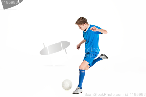 Image of Young boy with soccer ball doing flying kick