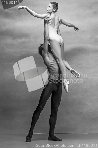 Image of Couple of ballet dancers posing over gray background