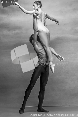 Image of Couple of ballet dancers posing over gray background