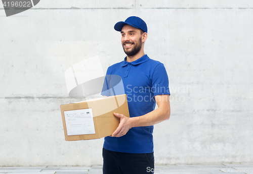 Image of happy delivery man with parcel box