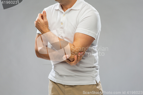 Image of close up of man suffering from pain in hand