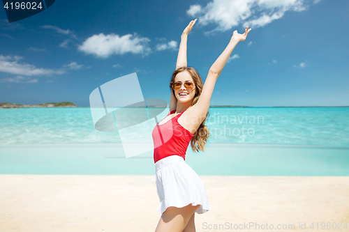 Image of happy young woman in sunglasses on summer beach