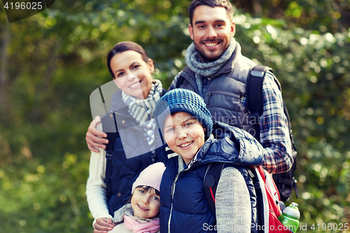 Image of happy family with backpacks hiking