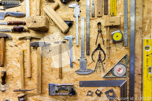 Image of work tools hanging on wall at workshop