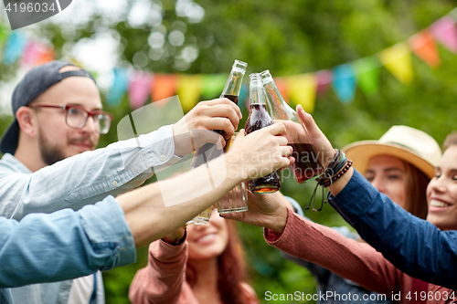 Image of happy friends clinking glasses at summer garden