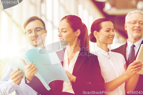 Image of business team with folders meeting at office