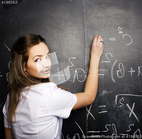 Image of portrait of happy cute student with book in classroom